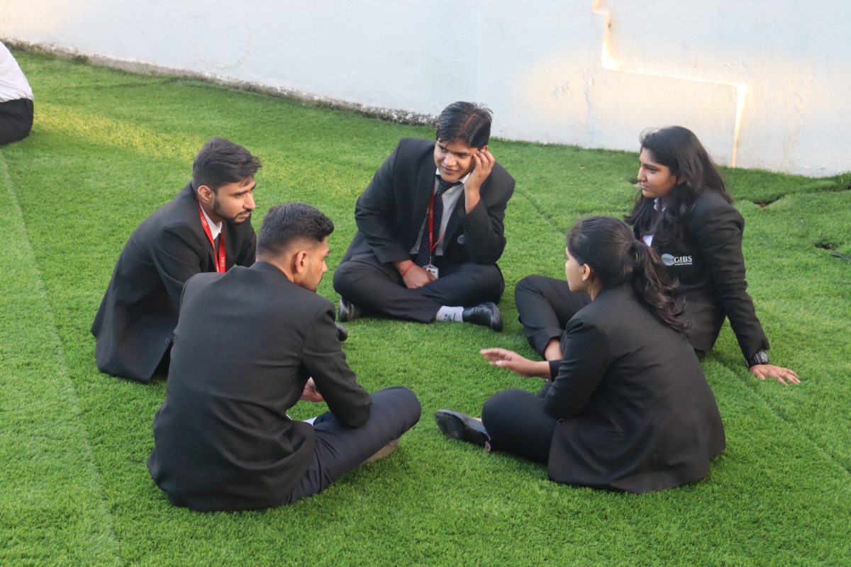 Students siting in lawn at GIBS Business School Bangalore